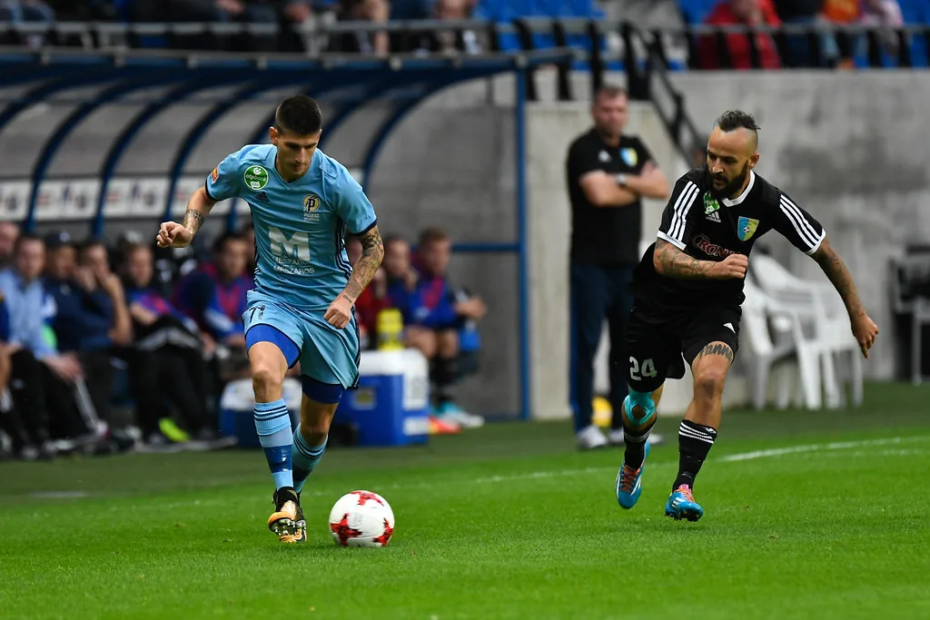 Two footballers competing for the ball during a domestic league match